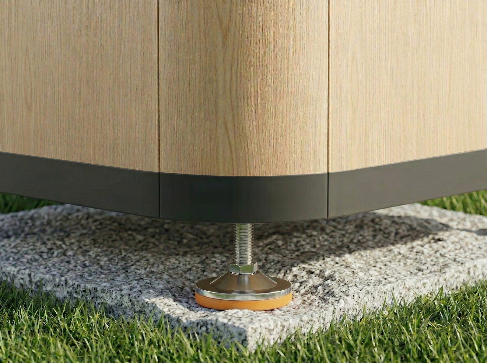 Close-up of a Garden Seven adjustable levelling support foot resting on a small concrete paver, replacing traditional ground anchors
